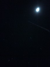 Moon, stars, and a contrail