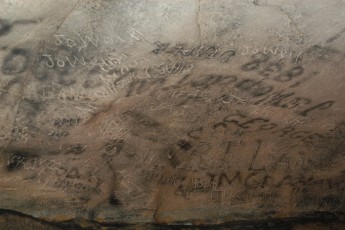 Graffiti made with lantern flames, leaving behind soot writing
