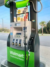 When designing gas pumps, who decided, more often than not, that the hose has to hang in front of the part a customer uses the most?