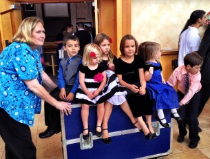Kids hitch a ride on the equipment case after church each week—cracks me up every time